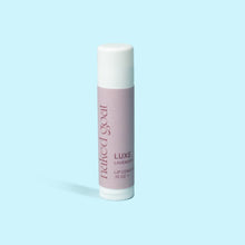Load image into Gallery viewer, The Naked Goat Luxe lip balm delivers a velvety fusion of Lavender and Sweet Orange for luxurious tranquility and deep hydration. It gracefully glides on and permeates the skin to restore, protect and heal.
