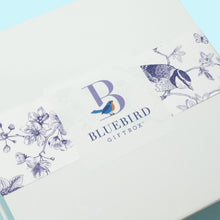 Load image into Gallery viewer, We designed this signature Bluebird Giftbox to bring blue skies and sunshine to mind and included the bluebird of happiness as a sender of joy. Spirits will be lifted as soon as the box is opened and will stay high as each gift inside is enjoyed.
