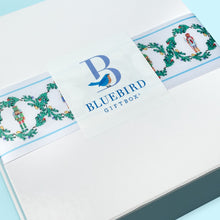 Load image into Gallery viewer, It&#39;s the most wonderful time of the year and this special Bluebird Giftbox is the perfect way to send joyful tidings to your favorite women! May their days be merry and bright with this curated care package wrapped with a lovely Nutcracker ribbon that helps them have a joyous season.
